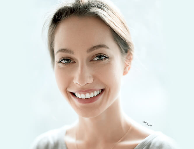 Smiling young woman, backlit.