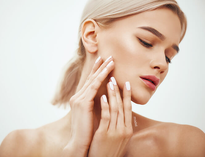 Woman touching face.