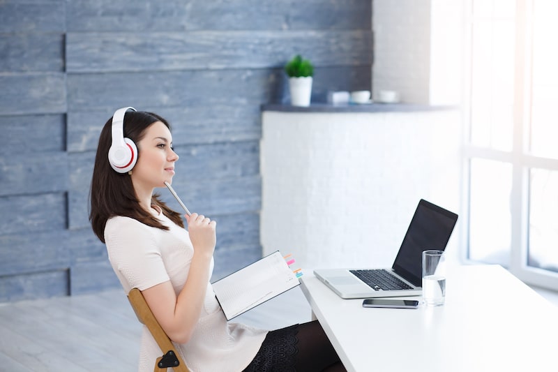 Woman sitting at a laptop doing research.