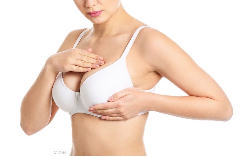 Woman performing a self breast exam